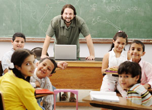 Male teacher with students in classroom
